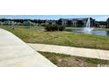 Picturesque community lake featuring a fountain, with walking path and grassy areas, offering a serene outdoor experience at 1083 Milford Way, Myrtle Beach, SC 29588