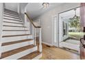 Inviting foyer with hardwood floors, white staircase and a view to the exterior at 109 Wofford Rd., Conway, SC 29526