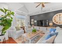 Bright living room with a cozy seating area, vaulted ceiling, and hardwood floors at 1415 Powhaton Dr., Myrtle Beach, SC 29577