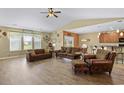 Cozy living room featuring a ceiling fan, hardwood floors, and a comfortable seating arrangement with natural light at 1725 Boyne Dr., Myrtle Beach, SC 29588