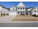 Inviting two-story home with a double porch, attached garage, and manicured lawn on a sunny day at 1838 Zodiac Court, Myrtle Beach, SC 29577