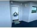 Condo front door featuring a lemon doormat and decorative floral wreath at 2100 Sea Mountain Hwy. # 520, North Myrtle Beach, SC 29582