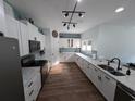 Modern kitchen features granite countertops, stainless steel appliances, stylish backsplash, and sleek white cabinetry at 236 Haley Brooke Dr., Conway, SC 29526