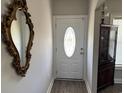 Foyer with decorative mirror, chandelier, and paneled front door with decorative stained glass at 2594 W Shore Dr., Longs, SC 29568