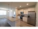Well-lit kitchen with white cabinetry, granite countertops, stainless steel appliances, and center island at 2681 Ophelia Way, Myrtle Beach, SC 29577