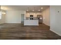 Open-concept living room and kitchen area with hardwood floors and bright, natural light at 2681 Ophelia Way, Myrtle Beach, SC 29577