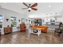 Spacious living room with hardwood floors, ceiling fan, comfortable seating, and natural light at 318 Board Landing Circle, Conway, SC 29526