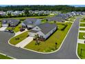 This aerial view shows a home with a pond view, landscaped yard, and backyard fence in a serene neighborhood at 4148 Da Vinci Dr., Myrtle Beach, SC 29579
