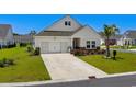 Charming single-Gathering home with well-manicured lawn, neutral siding, and a two-car garage in a sunny neighborhood at 4148 Da Vinci Dr., Myrtle Beach, SC 29579