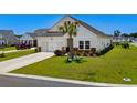 Charming single-Gathering home with well-manicured lawn, neutral siding, and a two-car garage in a sunny neighborhood at 4148 Da Vinci Dr., Myrtle Beach, SC 29579