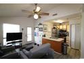 Comfortable living room boasting ceiling fan and adjoining open kitchen with stainless appliances at 423 Tree Top Ct. # 23-B, Myrtle Beach, SC 29588