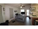 Bright living room offering abundant natural light, ceiling fan, and backyard access at 423 Tree Top Ct. # 23-B, Myrtle Beach, SC 29588