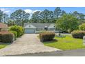 Beautiful one-story home with a well-manicured front yard and a charming water fountain at 4709 National Dr., Myrtle Beach, SC 29579