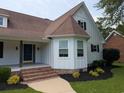 Close-up of a charming home's entrance, featuring brick steps and well-kept landscaping details at 4719 National Dr., Myrtle Beach, SC 29579