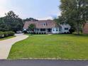 Beautiful home with a lush green lawn and curved driveway leading up to a well-maintained property at 4719 National Dr., Myrtle Beach, SC 29579