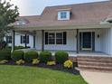 Inviting front porch with wooden posts and manicured bushes leading to the front door at 4719 National Dr., Myrtle Beach, SC 29579