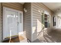 Charming condo entrance featuring a white door, sidelight, and a welcoming porch at 5870 Longwood Dr. # 201, Murrells Inlet, SC 29576