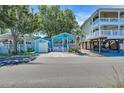 Charming beach cottage with blue siding and inviting front porch at 6001 - Q21 South Kings Hwy., Myrtle Beach, SC 29575