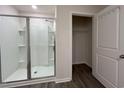 Bathroom featuring a glass shower with built-in shelving next to an open door to a closet with wire shelving at 6619 Colonial Dr., Myrtle Beach, SC 29572