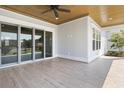 Inviting covered porch with tile flooring, ceiling fan, and sliding glass doors at 6850 Belancino Blvd., Myrtle Beach, SC 29579