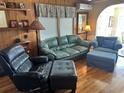 Cozy living room featuring wood paneling and comfortable seating at 710 S Waccamaw Dr., Garden City Beach, SC 29576