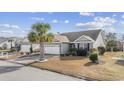 Charming home with well-maintained lawn, features a Corvette logo on the driveway at 755 Wintercreeper Dr., Longs, SC 29568