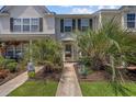 Charming townhome entrance featuring lush tropical landscaping and a welcoming walkway at 807 Wilshire Ln. # 807, Murrells Inlet, SC 29576
