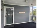 Exterior entrance to unit features 'Beach House' sign, door and a secure entryway at 812 S Ocean Blvd. # B-3, Surfside Beach, SC 29575