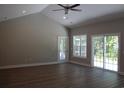 Bright living room with vaulted ceiling, ceiling fan, and sliding glass doors leading to the outdoors at Tbd 222 Persimmon Rd., Aynor, SC 29511