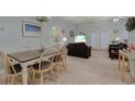 Open-concept living and dining area with carpeted floors and plenty of natural light at 1058 Sea Mountain Hwy. # 10-101, North Myrtle Beach, SC 29582