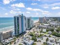 Aerial view of the Oceans One Resort near the beach, other hotels, and various streets with cars at 107 S Ocean Blvd. # 503, Myrtle Beach, SC 29577