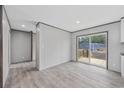 Open living area with wood-look flooring and sliding glass doors to outdoor deck at 108 Forman Way, Aynor, SC 29511