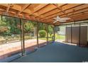Spacious screened patio with ceiling fan overlooking a brick patio and landscaped backyard at 123 Retreat Pl., Little River, SC 29566