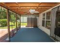 Enclosed patio featuring a ceiling fan and views of the landscaped backyard at 123 Retreat Pl., Little River, SC 29566