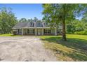 Charming home with a welcoming front porch and well-maintained lawn and gravel driveway at 140 Pixie Dust Ct., Myrtle Beach, SC 29588