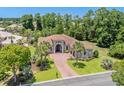 Beautiful aerial view of a Mediterranean-style home with lush landscaping and a brick driveway at 1694 Serena Dr., Myrtle Beach, SC 29579