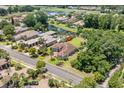 Aerial view of a home with a red tile roof, landscaping, and community golf course at 1694 Serena Dr., Myrtle Beach, SC 29579