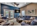 Comfortable living room with a blue accent wall, plush seating, and access to the backyard at 1733 24Th Ave. N, North Myrtle Beach, SC 29582