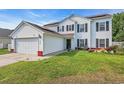 Inviting two-story home with white siding, black shutters, green lawn and solar panels at 180 Weeping Willow Dr., Myrtle Beach, SC 29579