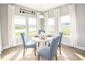 Bright dining area with a view of the river, featuring a round table and four chairs at 219 Atlantic Breeze St., Myrtle Beach, SC 29572
