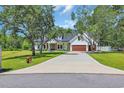 Charming two-story house with an expansive driveway and well-manicured lawn at 2192 Eastwoods Dr., Conway, SC 29526