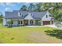 Stunning home featuring a covered porch with wooden columns and neatly trimmed landscaping at 2192 Eastwoods Dr., Conway, SC 29526