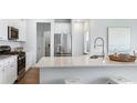 Bright kitchen boasts stainless appliances, stone countertops and white cabinets at 222 Atlantic Breeze St., Myrtle Beach, SC 29572