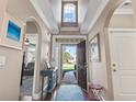 Bright entryway with high ceilings, archways, and a view through to the front yard, leading to the main living area at 408 Capua Ct., Myrtle Beach, SC 29588