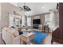 Bright living room with hardwood floors, large windows, elegant decor, and a ceiling fan for year-round comfort at 408 Capua Ct., Myrtle Beach, SC 29588