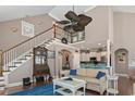 Open-concept living space with hardwood floors, stairs to an upstairs landing, and flow to kitchen and living areas at 408 Capua Ct., Myrtle Beach, SC 29588