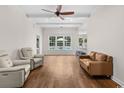 Spacious living room featuring hardwood floors, recessed lighting, ceiling fan and great natural light at 409 Cypress View Ave., Little River, SC 29566