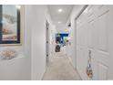 Bright hallway with neutral carpet, closet, and nautical decor accents at 4400 Turtle Ln. # 2-D, Little River, SC 29566