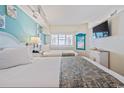Cozy bedroom with two beds, bright decor, and a mounted TV at 4800 S Ocean Blvd. # 706, North Myrtle Beach, SC 29582