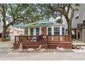 Charming exterior view featuring a spacious deck with blue umbrellas and beachy decor at 6001 - 1040 S Kings Hwy., Myrtle Beach, SC 29575